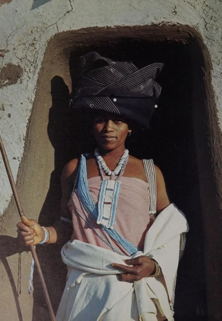 Xhosa tribe of South Africa. Traditional Xhosa dress composed of wrapped blankets, painted cloth skirts, beaded collars and necklaces, beaded headpieces, and arm ornaments.