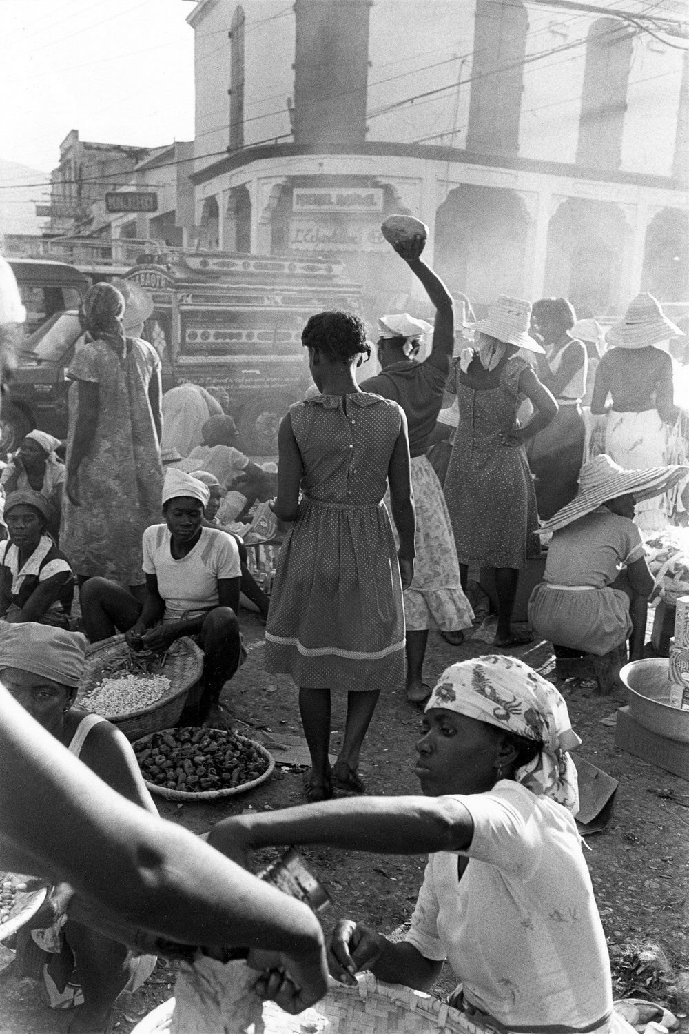 Woman lifting fruit on downtown street, Port-au-Prince, Haiti, 1985. Gary Monroe — Source: Unknown
