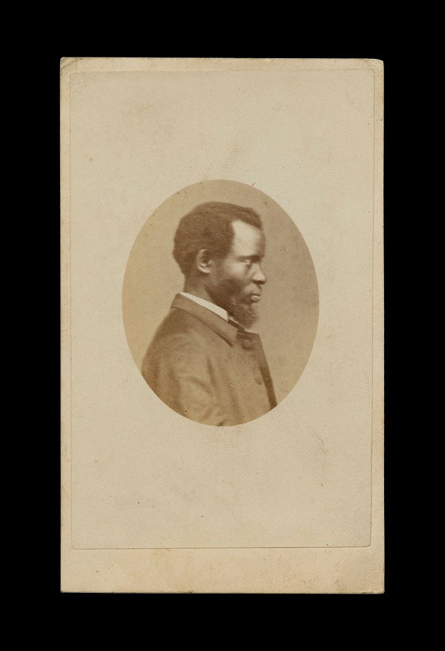 Profile portrait of a Black man with beard, presented in an oval vignette against a plain ground.  Photographer: unknown ,  United Kingdom , circa 1860s–1870s.