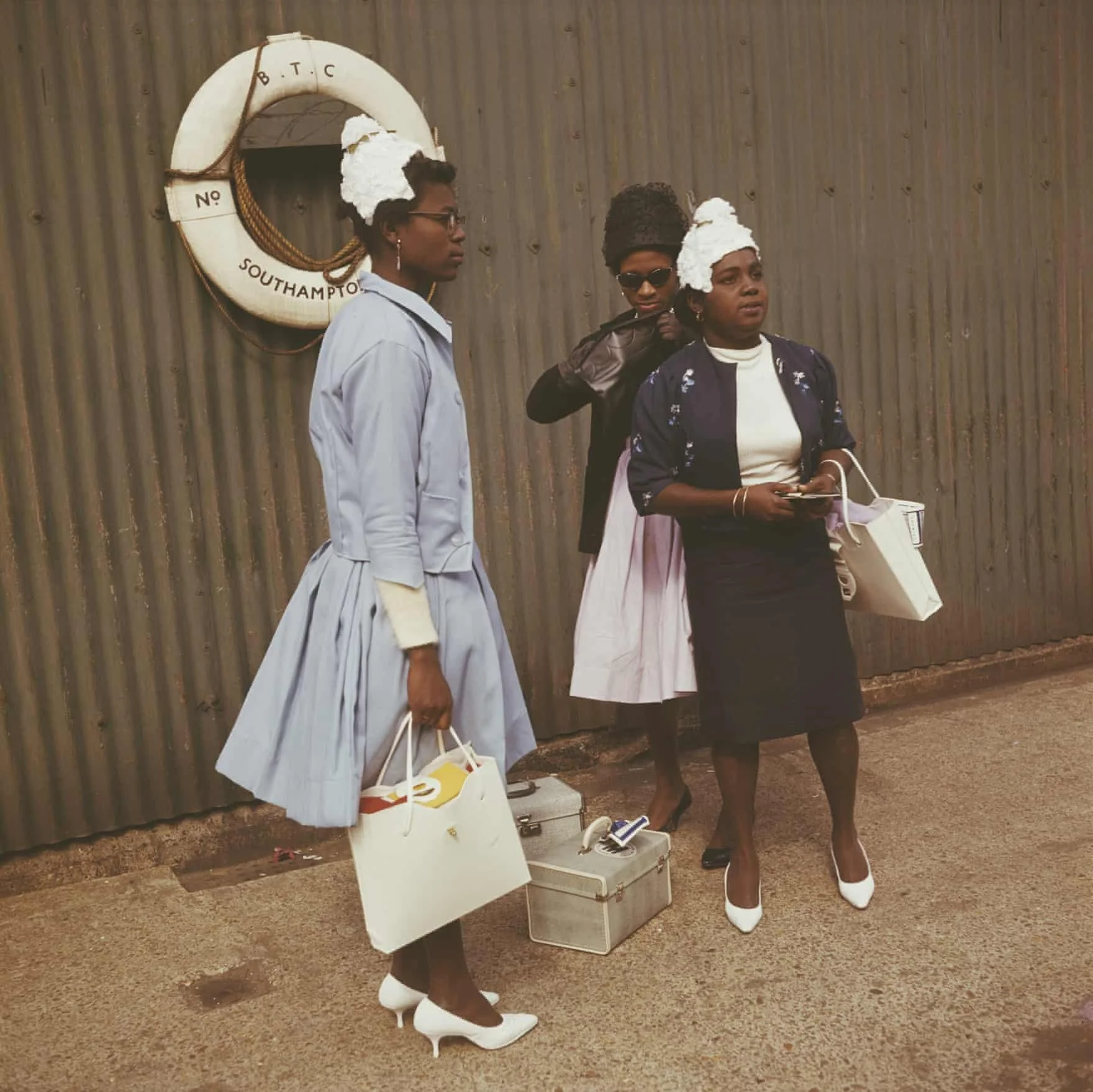 Three women wait with their hand luggage at Southampton in 1962
Photograph: Popperfoto/Getty Images.  'Windrush arrivals embark on a new life in UK – archive photos', Joanna Ruck, The Guardian, Apr 2018. 