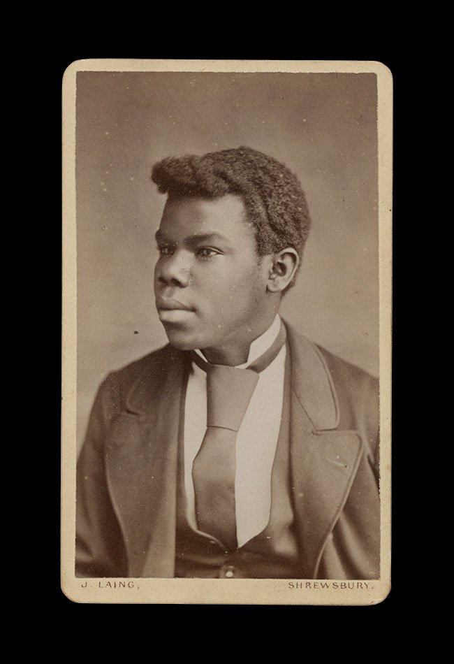 Three-quarter portrait of a young Black man in formal attire, turned slightly in profile. Photographed by J. Laing , Shrewsbury, England , circa 1880s–1890s.