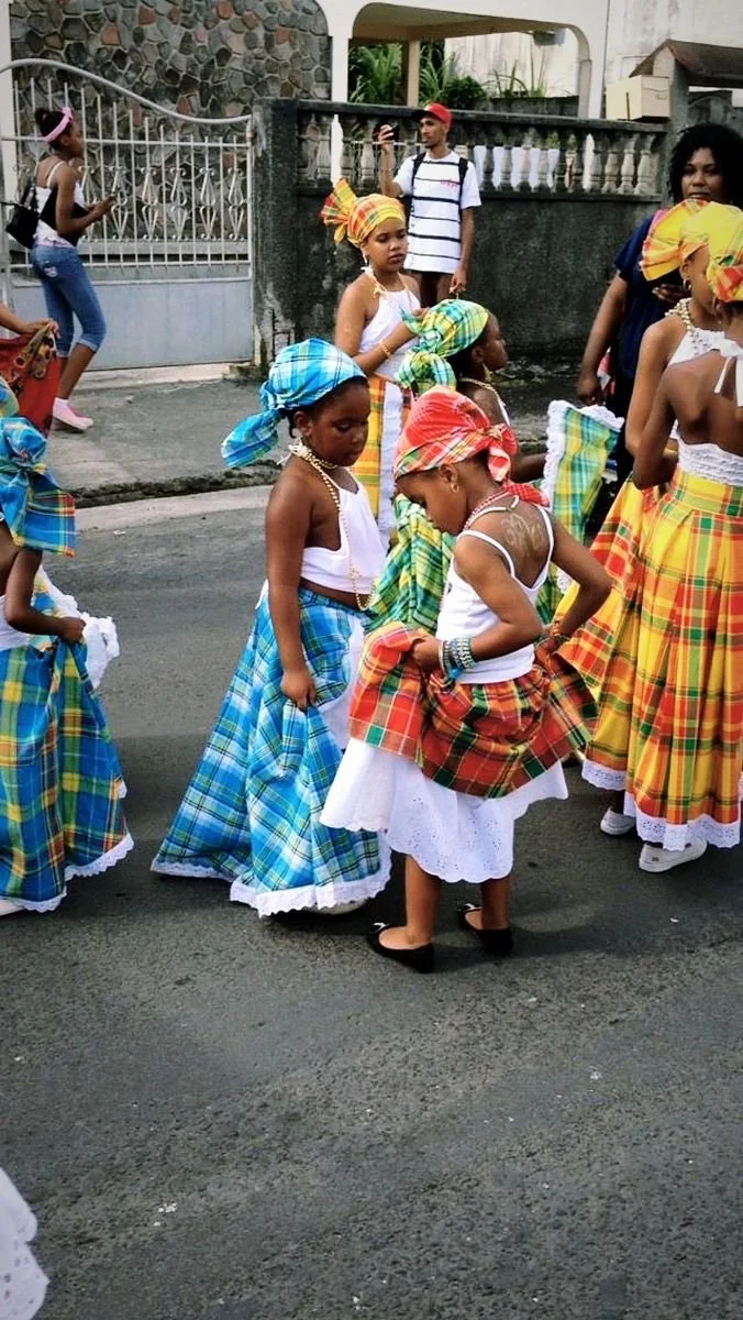 Guadeloupean children wearing madras skirts and headwraps.
