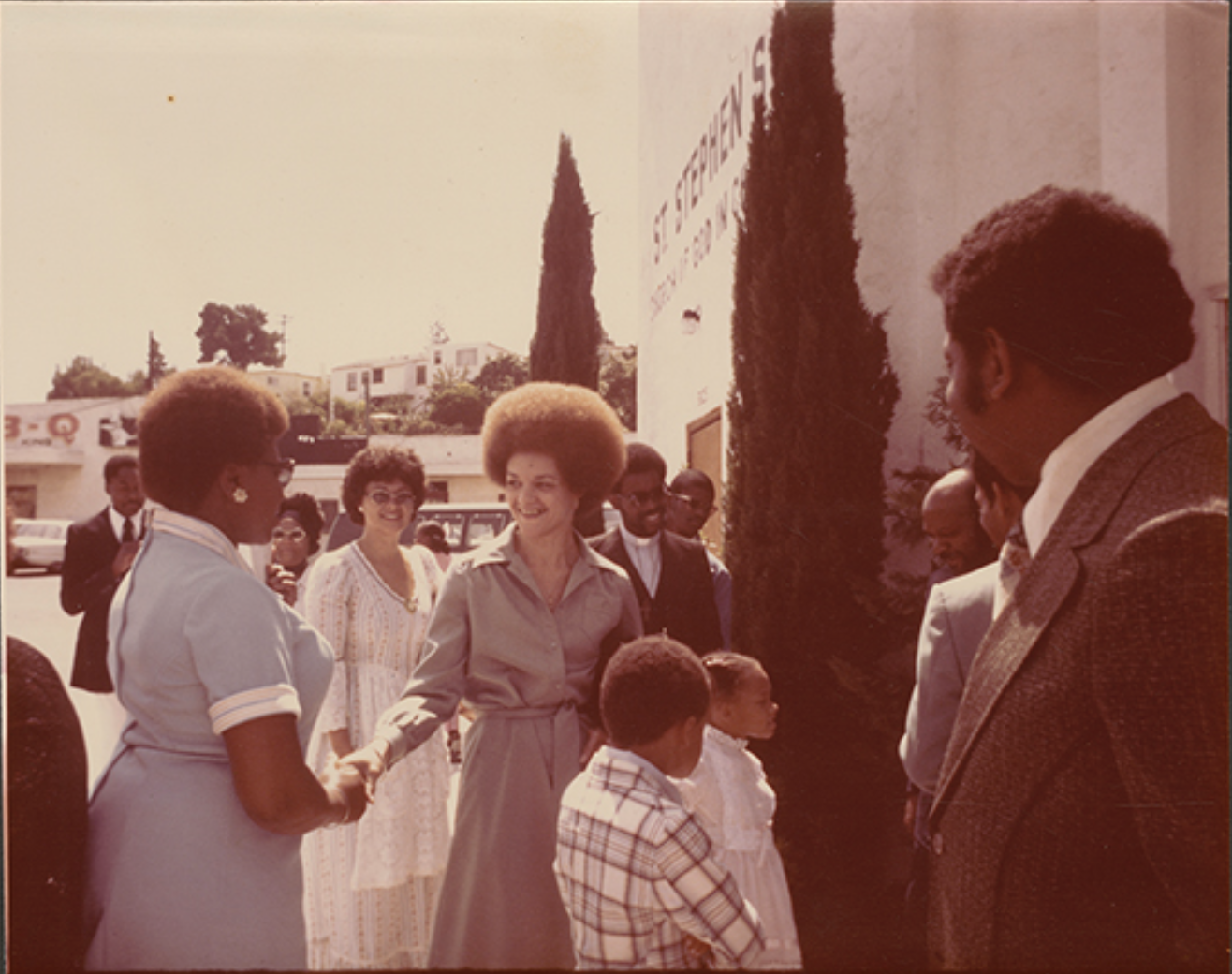 Photograph of Kathleen Cleaver greeting community members, c. 1960s. Emory University Archives.