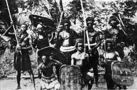 A group of Igbo warriors in ancient battle dress at a warriors funeral. Photo: M. D. W. Jeffreys, 1956.
