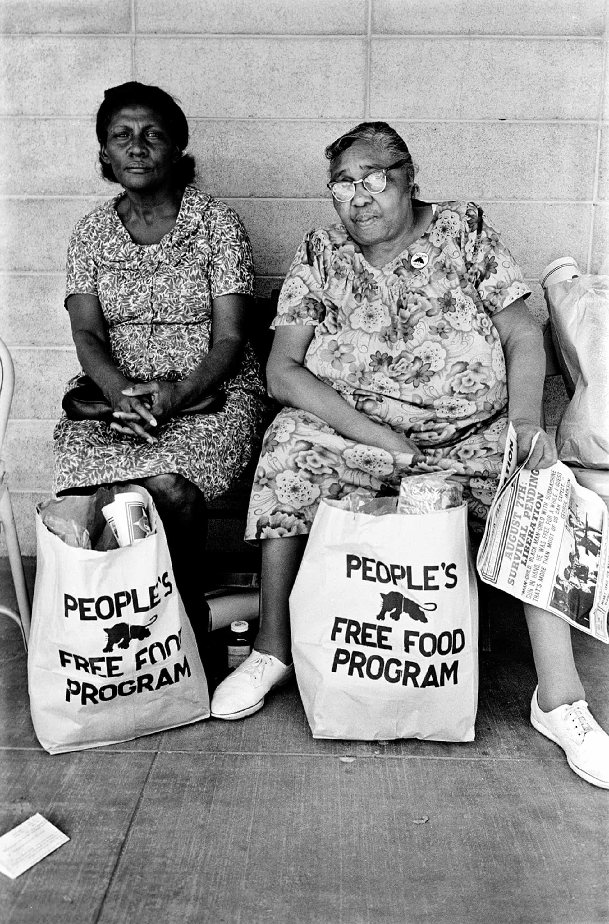 Two women with bags of food at the People’s Free Food Program, one of the Panther’s survival initiatives, Palo Alto, California, 1972