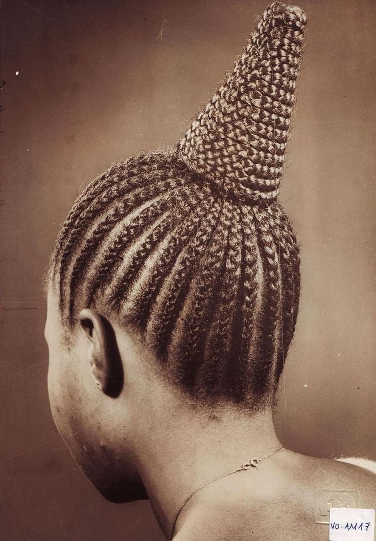 Woman with elaborate braided cone-shaped hairstyle, photographed by J.D. ’Okhai Ojeikere, from the Hairstyles series (Nigeria, 1968–1975). 