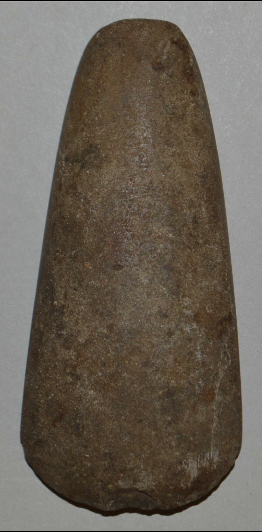 Adze Blade. Early 19th century. Stone; Height 10 cm × Width 4.50 cm × Depth 1.70 cm. Caribbean, Americas. This stone adze blade was excavated in the Caribbean and reflects Indigenous and early historic lithic tool traditions in the region. Adzes were