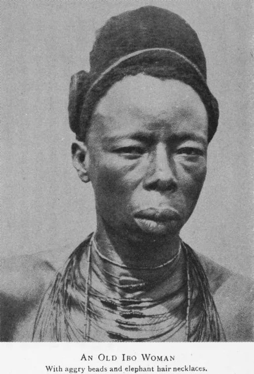 An elderly Ibo woman wearing aggry beads and elephant necklace. Photographed by Basden in 1921. 