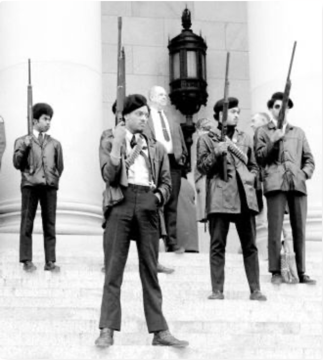 Photograph of Seattle Black Panther Party members standing armed on the steps of the Washington State Capitol in Olympia during a protest against proposed firearm legislation. Taken on February 28, 1969. Washington State Archives.