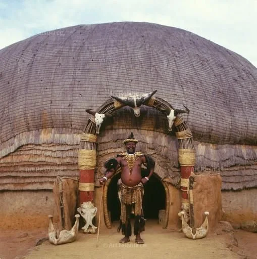 Zulu man standing outside his beehive hut, KwaZulu-Natal, South Africa. Photograph by Stephanie Colasanti. © Stephanie Colasanti / The Art Archive at Art Resource, NY.