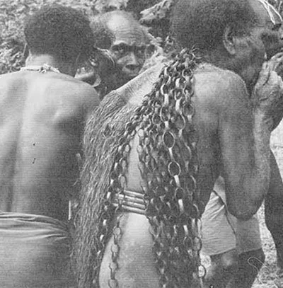 "The same Kwaio warrior seen in page 35, #3 The woven chain down his back is a mark of prestige: each link represents a pig he of his father successfully stole in their careers the chain is donned on special occasions after retirement from the game o