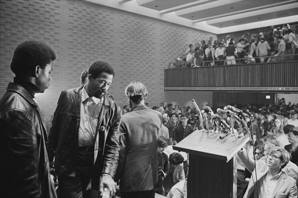 Photograph of Eldridge Cleaver speaking on stage at American University before an audience. Taken on October 18, 1968 by photographer Marion S. Trikosko. Library of Congress Prints and Photographs Division.