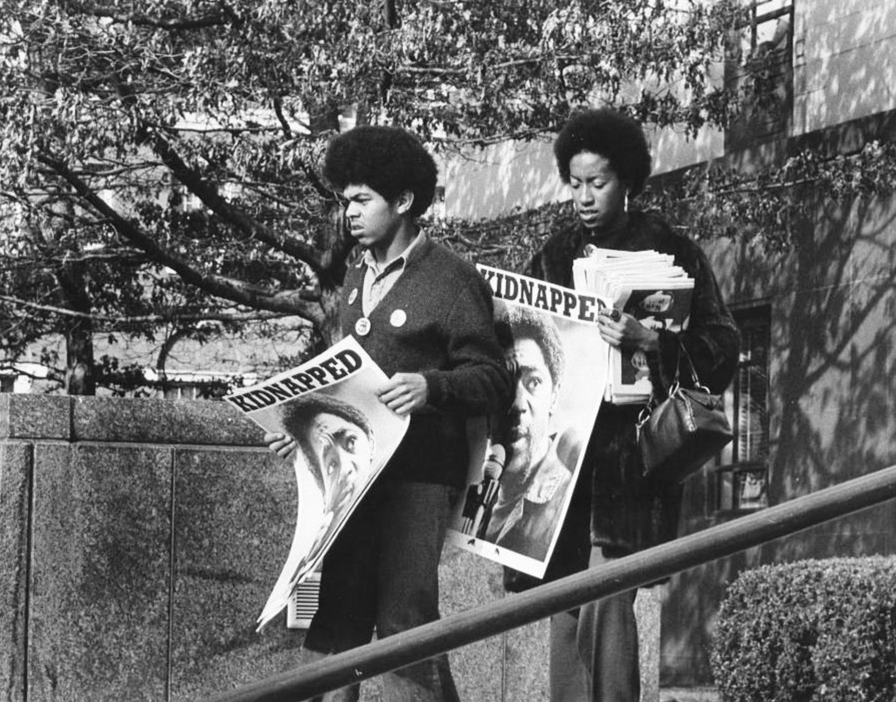 Photograph of Black Panther Party members distributing “Free Huey” materials and newspapers featuring Huey P. Newton. Photographer unknown, c. late 1960s. Aaron Dixon Collection, Seattle Civil Rights & History Project.