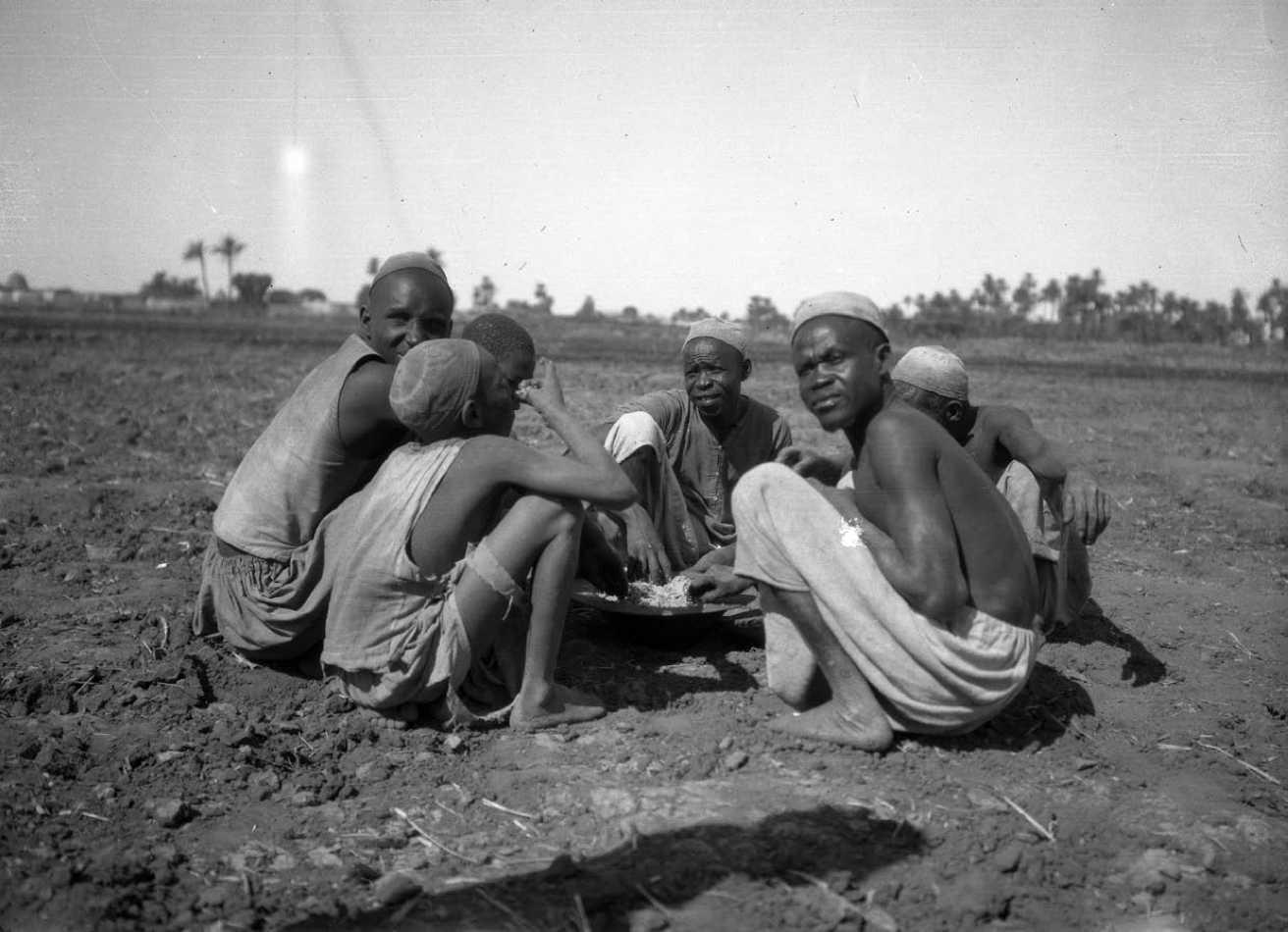 Men Eating in a Field Near the Town of Hafir, 1907. Oriental Institute, University of Chicago. P. B930