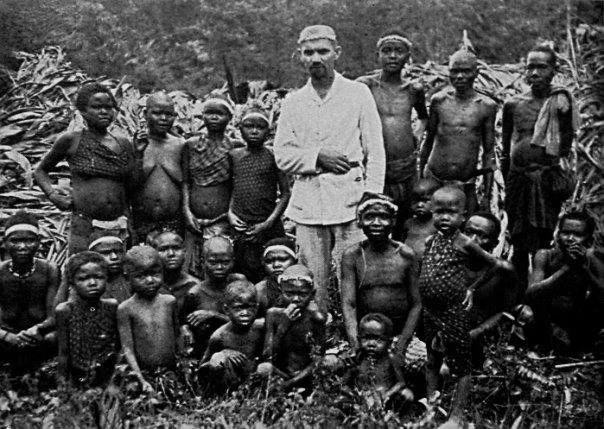 Portrait of a man centered alongside Mantiq tribe members and children — Image via Kevin  Alfred 