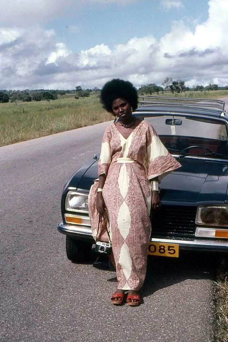 Tanzanian woman wearing a patterned kaftan-style dress, circa 1970s.