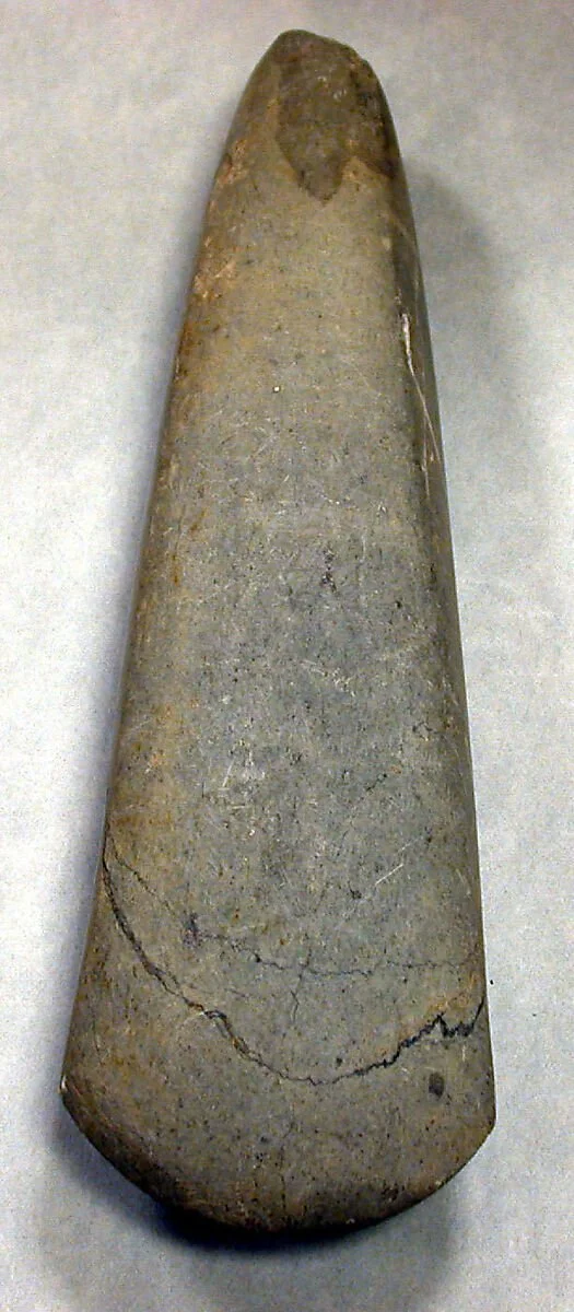 Celt, 7th–10th century, Taíno culture, Puerto Rico, Caribbean. Carved stone (H. 24.4 cm × W. 8.6 cm [9 5/8 × 3 3/8 in.]). This polished stone implement was created by Taíno artisans using pecking and grinding techniques to shape and smooth the stone 