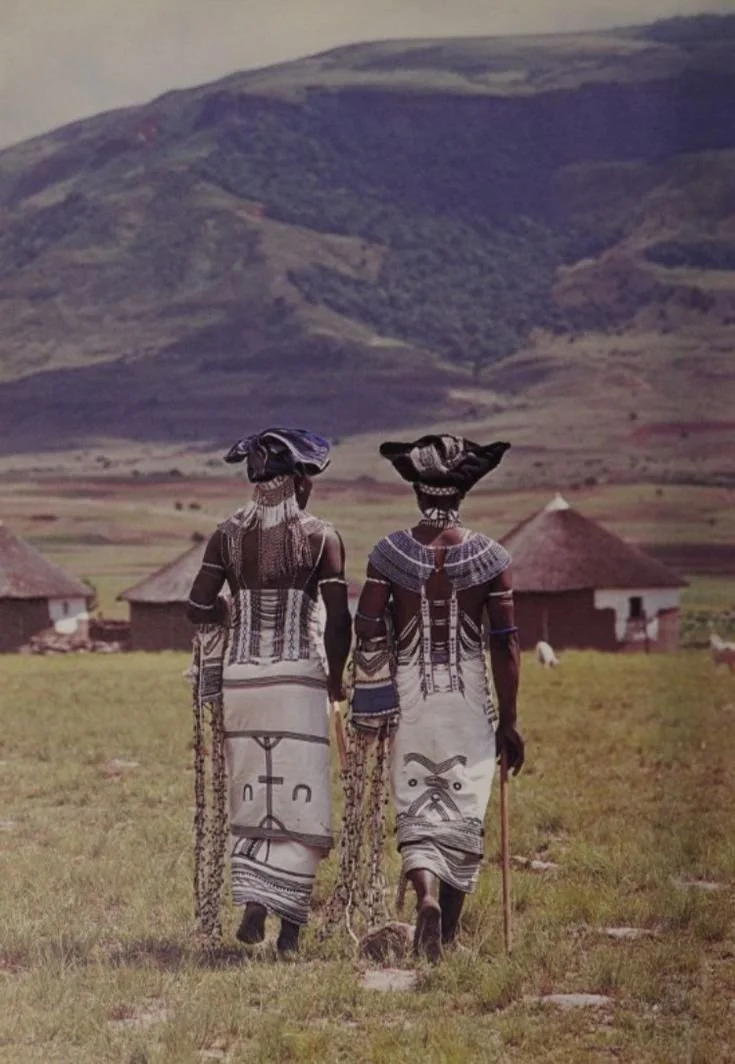 Xhosa tribe of South Africa. Traditional Xhosa dress composed of wrapped blankets, painted cloth skirts, beaded collars and necklaces, beaded headpieces, and arm ornaments.