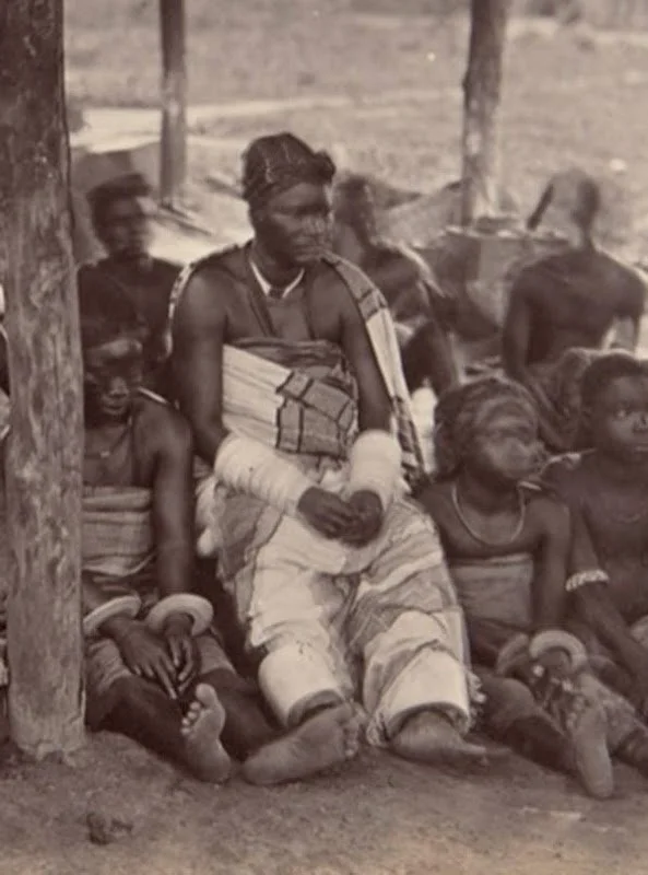 A trader. c. 1889. This picture taken c. 1889, possibly by G. F. Packer credited with other photos from the Niger and Önïcha (Onitsha) (and of Önïcha trading women), is annotated as 'Trader from Timbuctou' on the right and 'Rich Trading Woman' on the