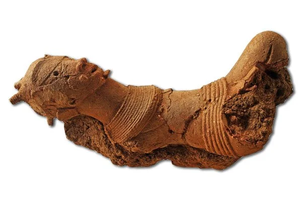 The triangular eyes and parted lips of this Nok terracotta figurine are characteristic of an artistic style that endured for millennia even after the Nok culture disappeared. This one may represent a deity, an ancestor, or be a portrait. (Courtesy Ba