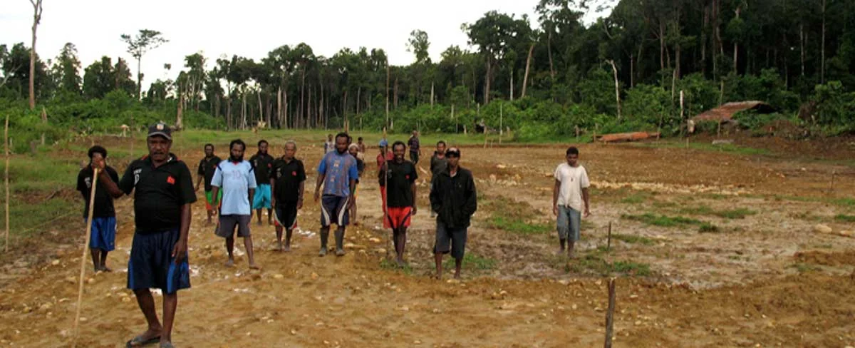 Ten Western Dani evangelists at the Danuwage airstrip, July 2011, with six Korowai in the distant background and at right. 