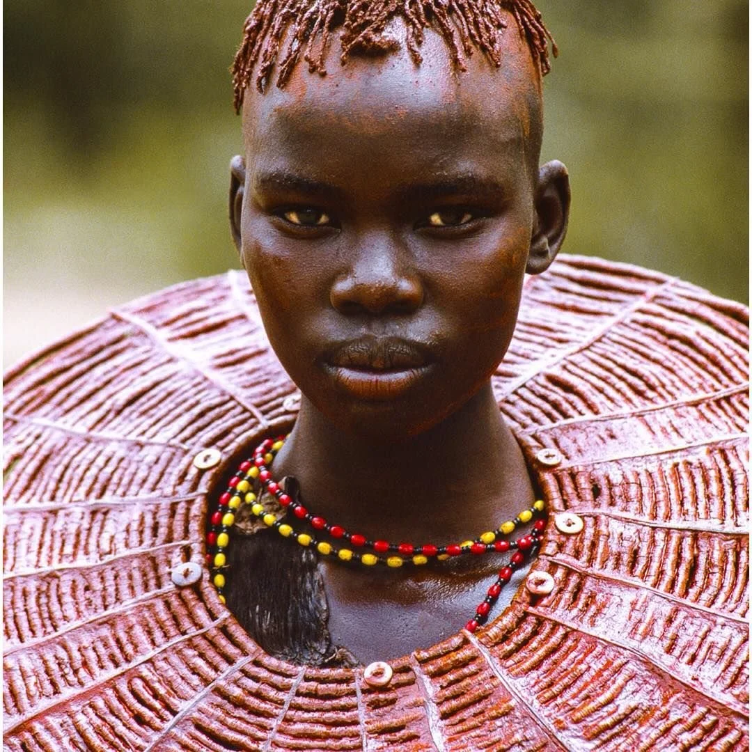 Pokot-Kenya: This fiercely beautiful young woman is wearing a necklace made from the stem of an asparagus tree.