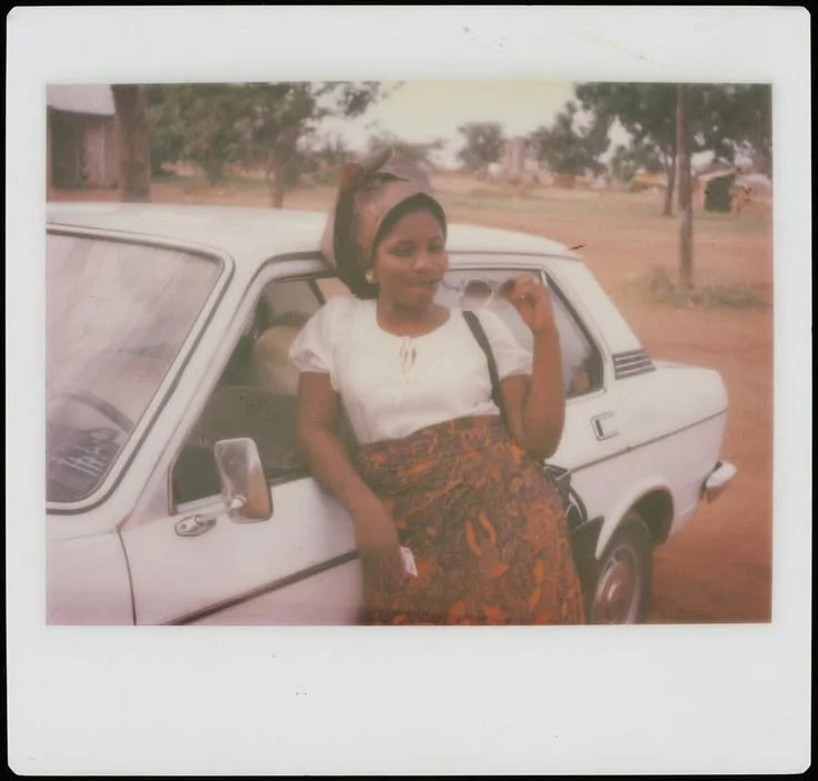 Cindy Deeds wearing a headwrap and a patterned skirt in Nigeria, 1978.