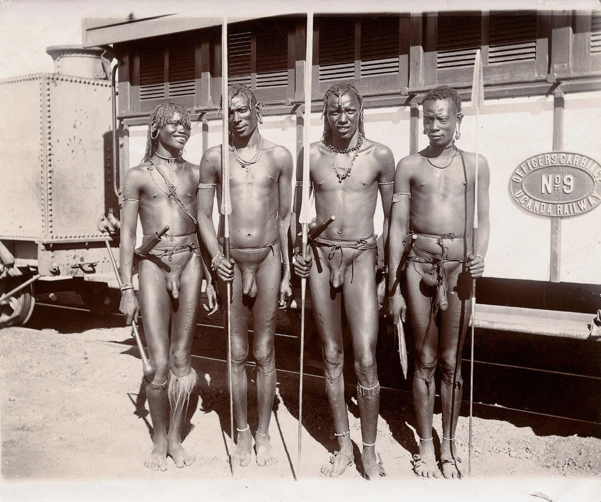 Four Young Masai Men, Carrying Spears, Standing beside a Train. Photograph, ca.1900. photoprint. Wellcome Collection, JSTOR, https://jstor.org/stable/community.24906003.
