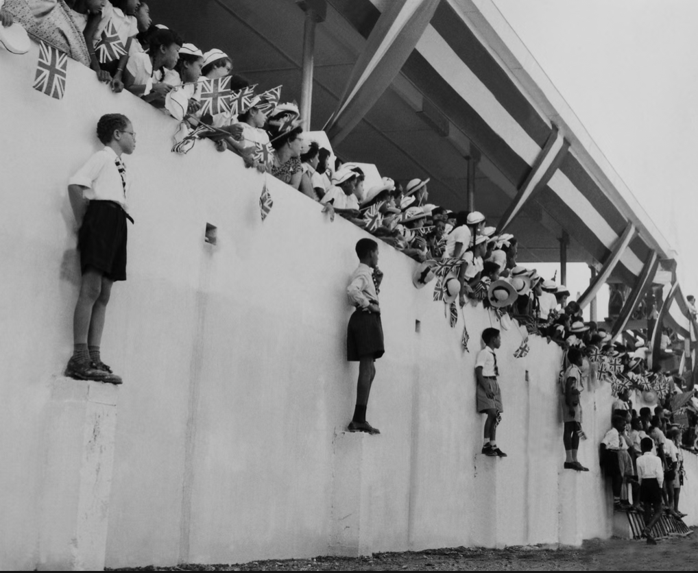Crowds wait in Trinidad and Tobago for the arrival of Princess Margaret (1955) [Photograph]. In 100 years of photography in the Caribbean in pictures. The Guardian.