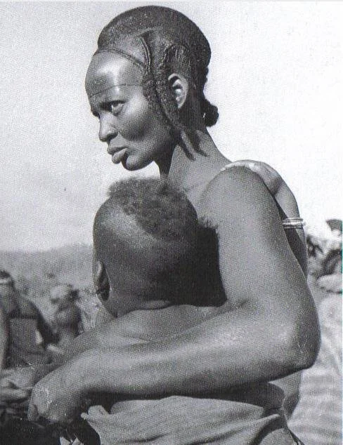 Woman from northern Dan village of Biankuma, Ivory Coast, West Africa. With her forehead lined with a braids at each side, between the ear and the cheek. Photographed by Vandenhoute, 1938-39, IV.F.V. 89-10.