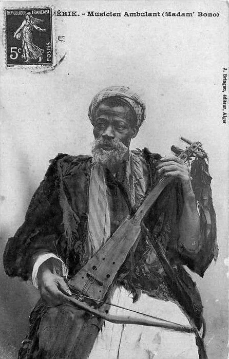 Gnawa musician, Madam' Bono, playing a guembri.