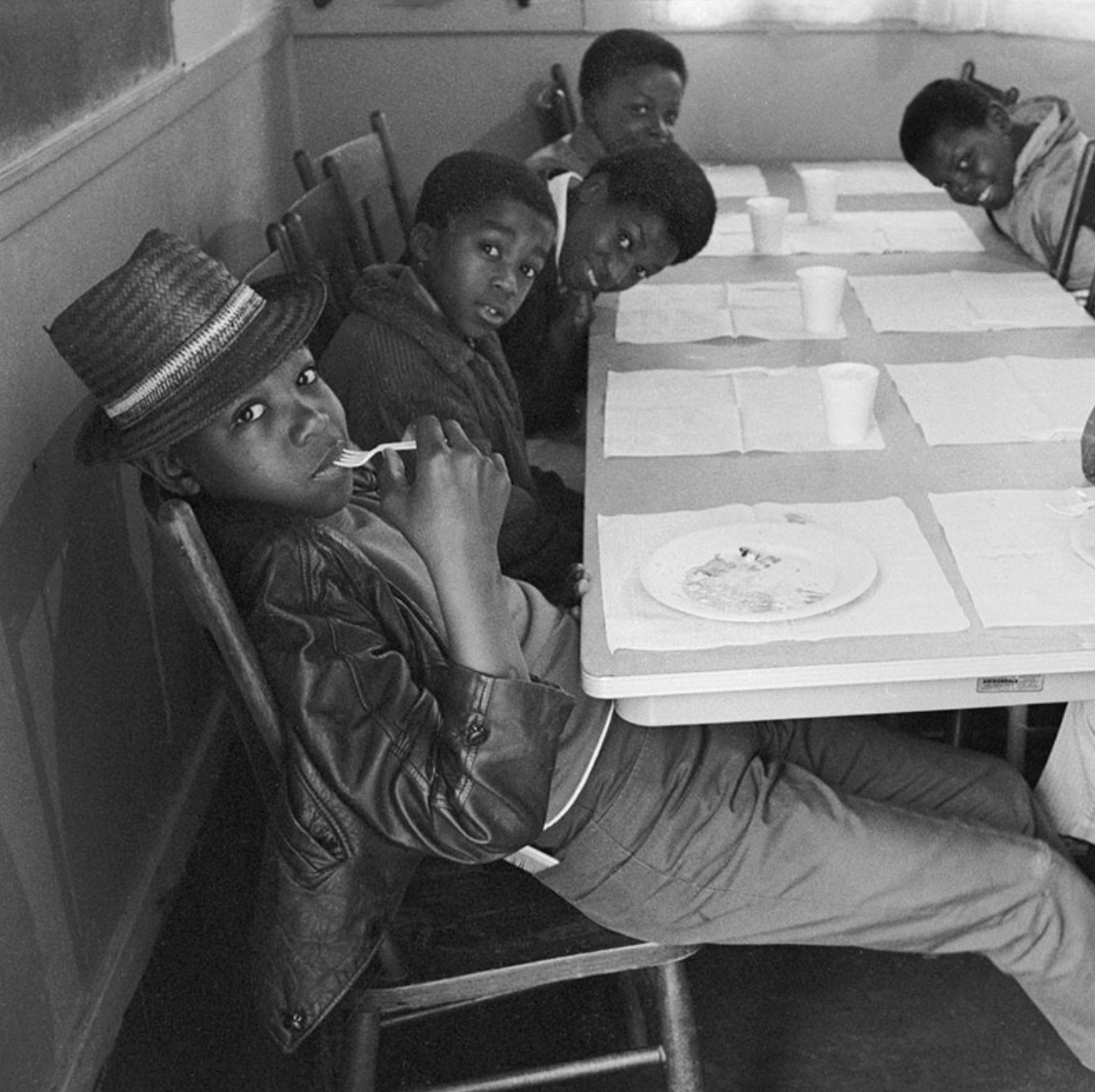 Photograph of children seated at a table during the Black Panther Party’s Free Breakfast for Children Program. Photographer unknown, c. late 1960s to early 1970s.