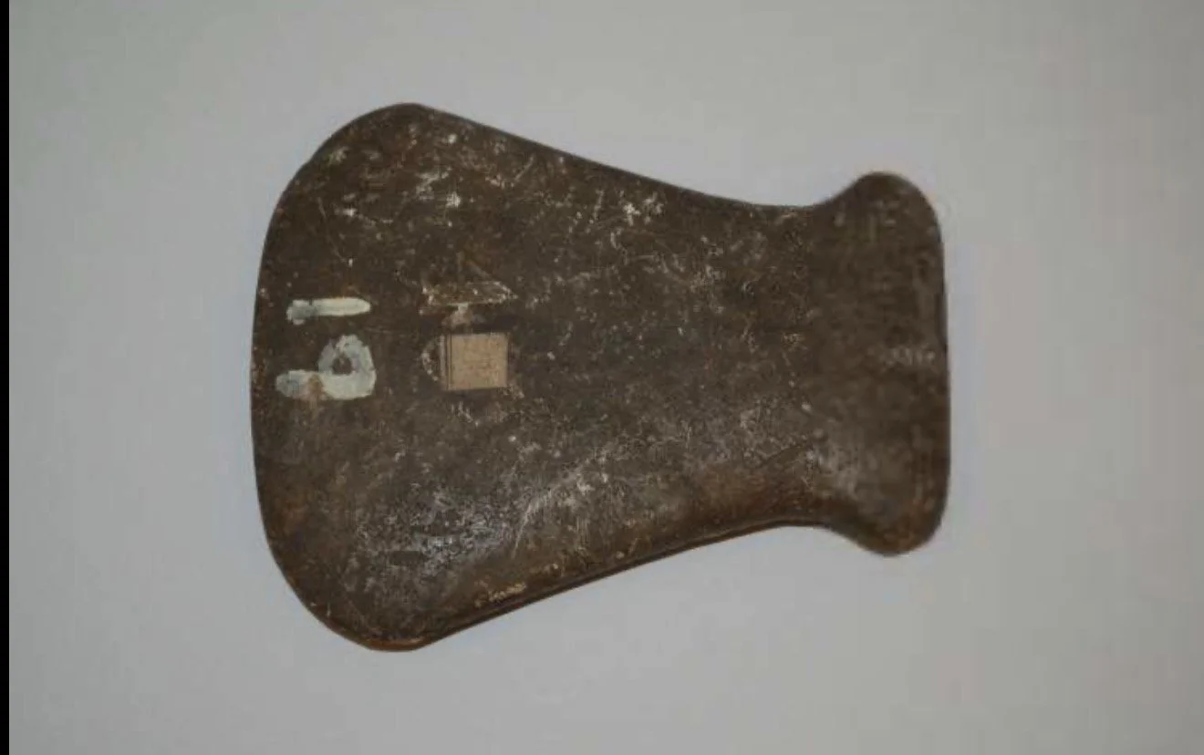 Stone Handaxe (Celt Type). Stone; Length 14 cm × Width 11.50 cm × Depth 1.80 cm. Caribbean, Americas. This stone handaxe, featuring a flared handle and wide blade, represents a lithic form commonly found in the Caribbean and associated with Indigenou