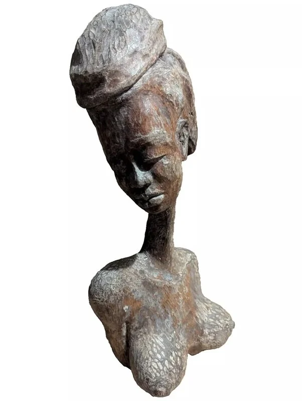 Ludovic Booz (Circa 1970’s), “Woman Bust”, Wood Sculpture, Size: 21″ X 10″.
Ludovic Booz was a Haitian artist who was born on June 16, 1940, in Aquin and died on February 2, 2005. Booz had a natural talent for drawing from an early age, using what