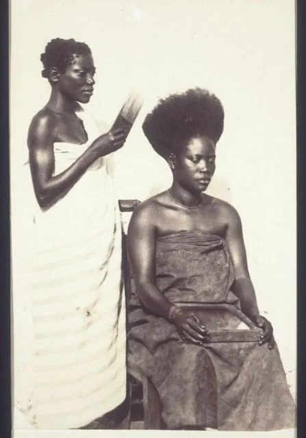 Young women in a hair salon in Abetifi-Kwahu, Ghana, around 1890-1910. From Basel Mission Archives.