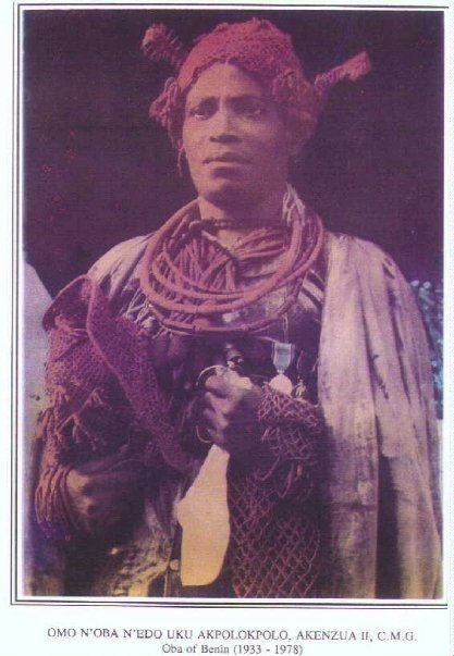 Oba Akenzua II, the King of Benin from 1933 to 1978 in full traditional regalia, which includes significant coral garments and headpiece.