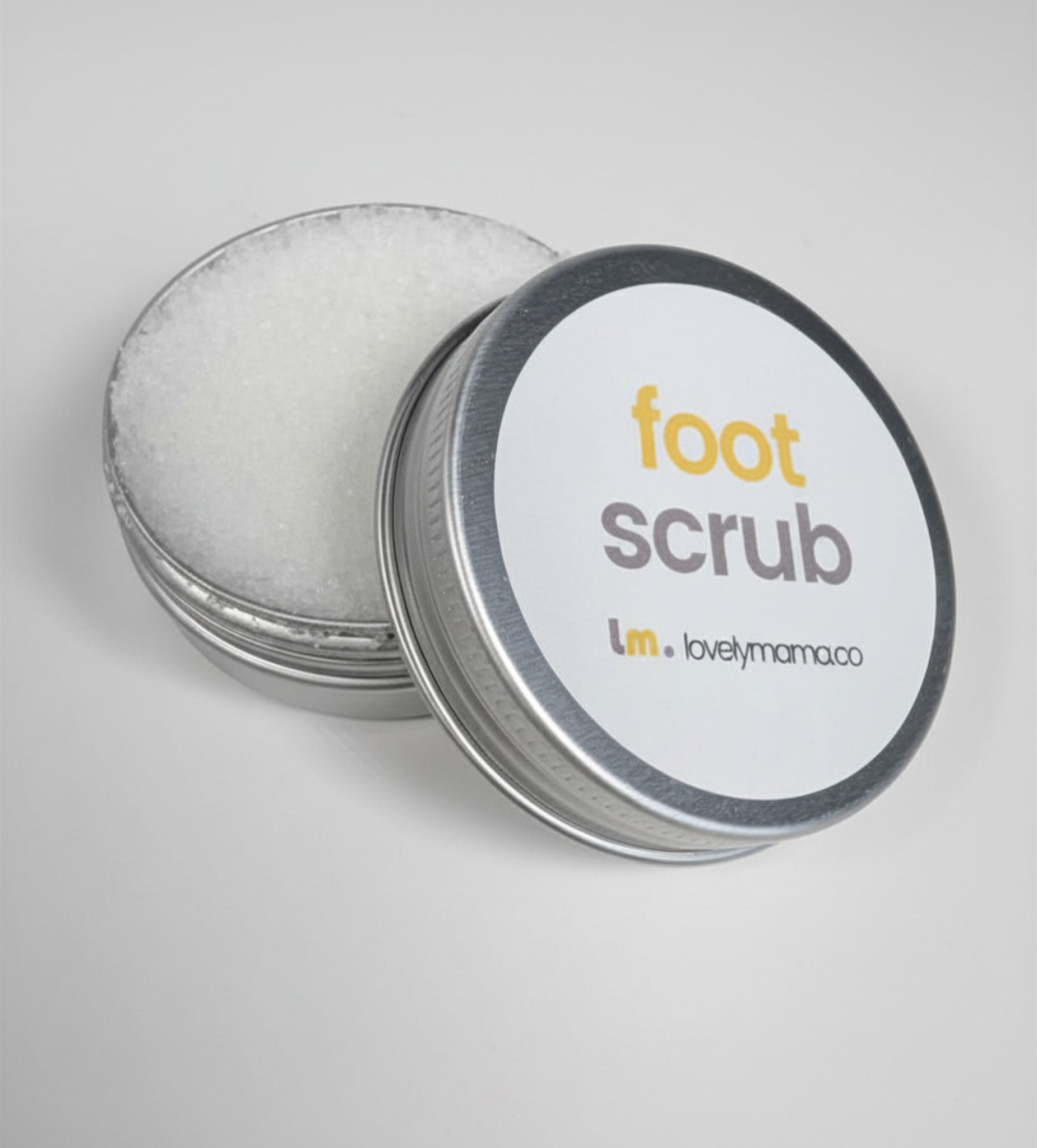 open tin of foot scrub showing the mineral salts infused product