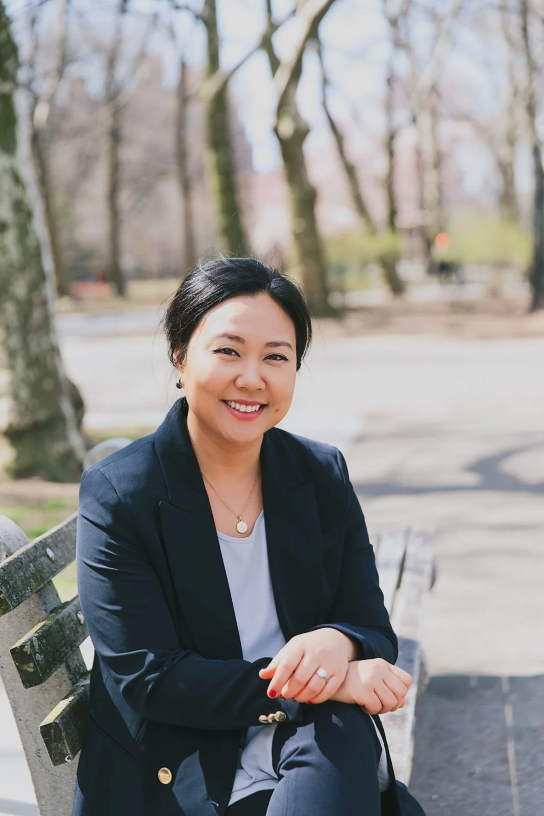 Dr. Angela Gwak, founder of Resonance Psychology, seated outdoors and smiling