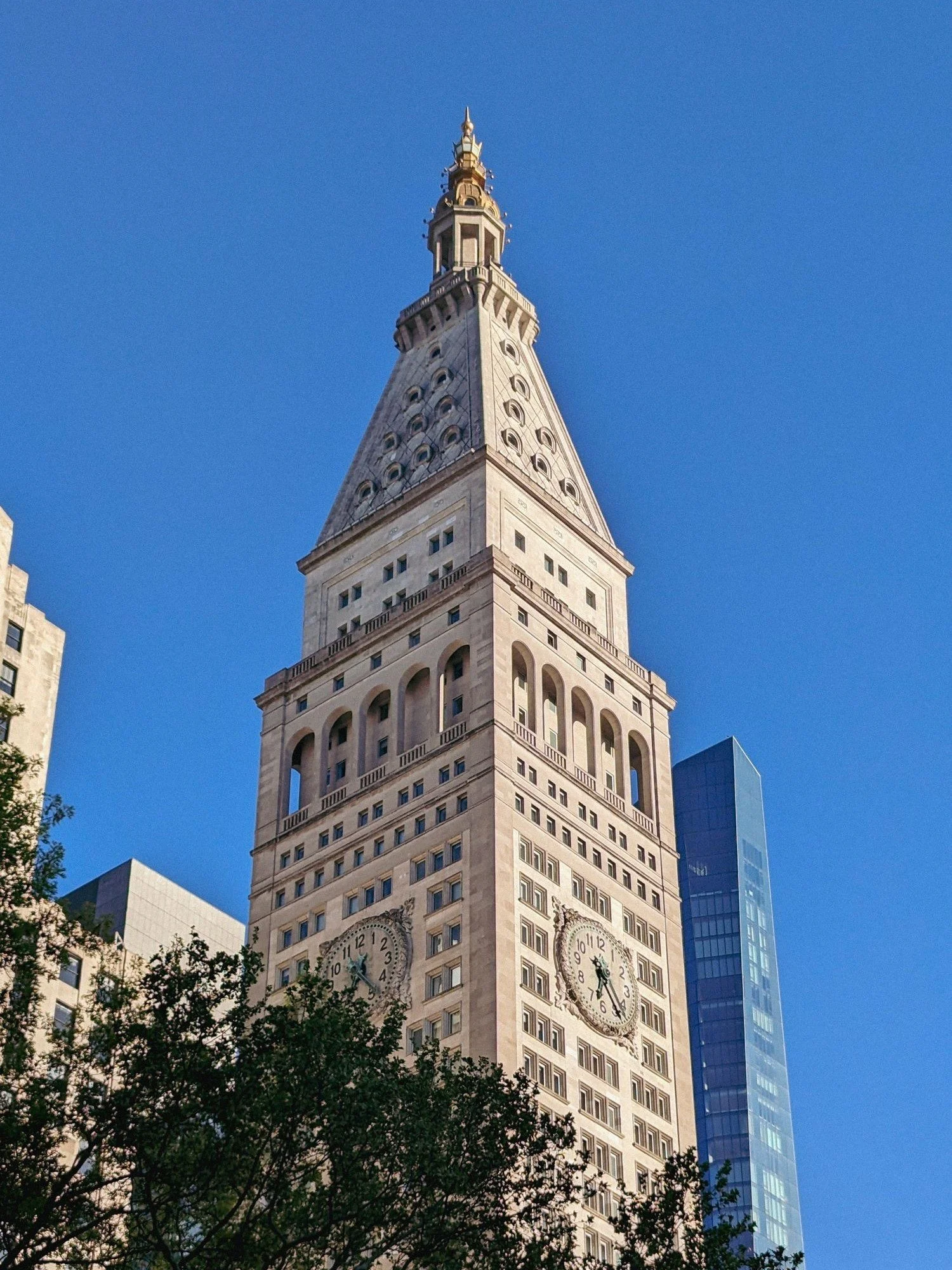 The Metropolitan Life Tower clock rising above the trees of Madison Square Park, a short walk from the practice's office