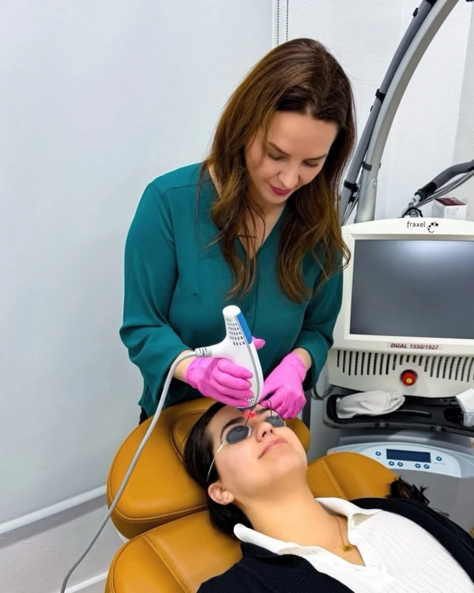 Dr. Lina Kennedy performing a Clear + Brilliant laser treatment on a patient wearing protective eye shields