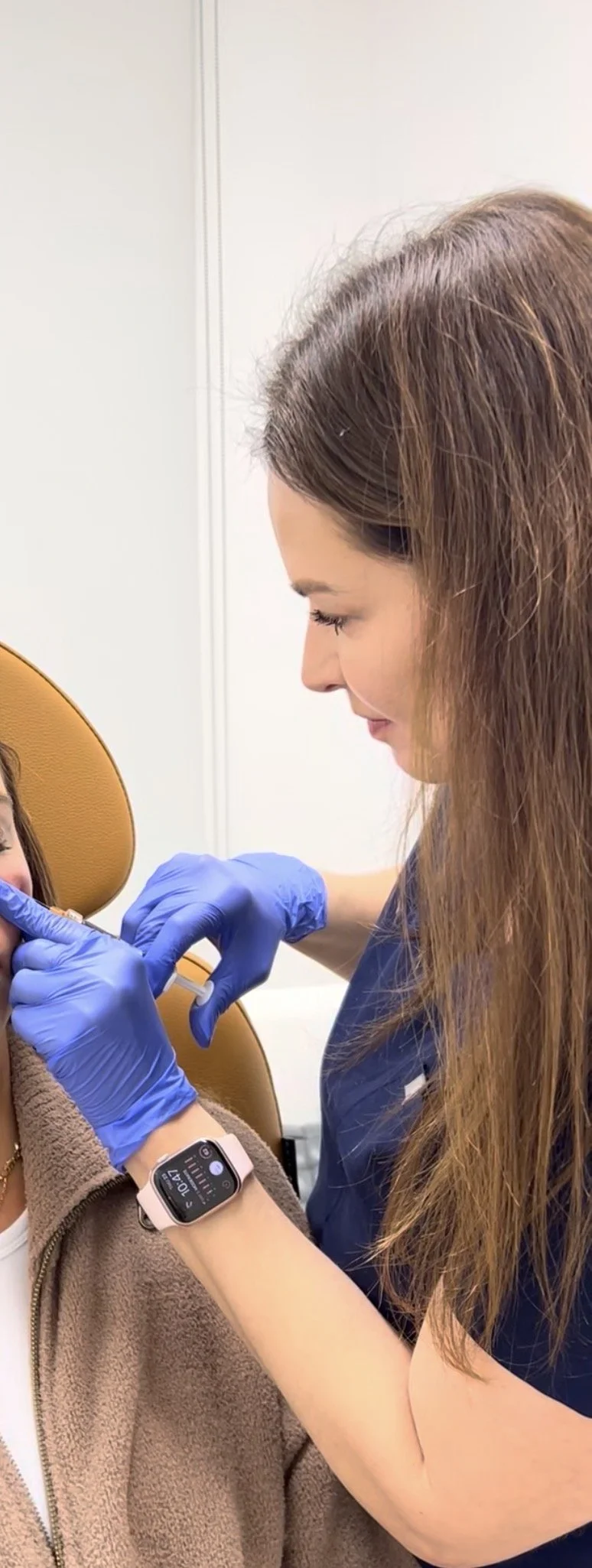 Dr. Lina Kennedy injecting dermal filler into a patient's cheek at Grace Dermatology