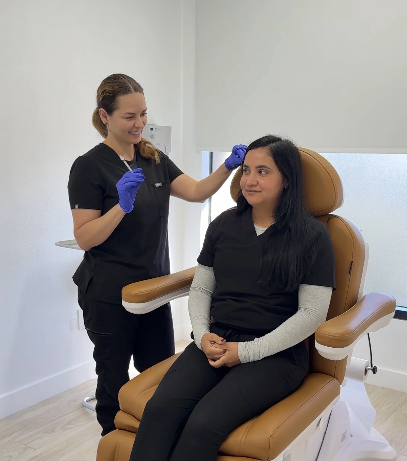 Dr. Lina Kennedy preparing to inject a seated patient