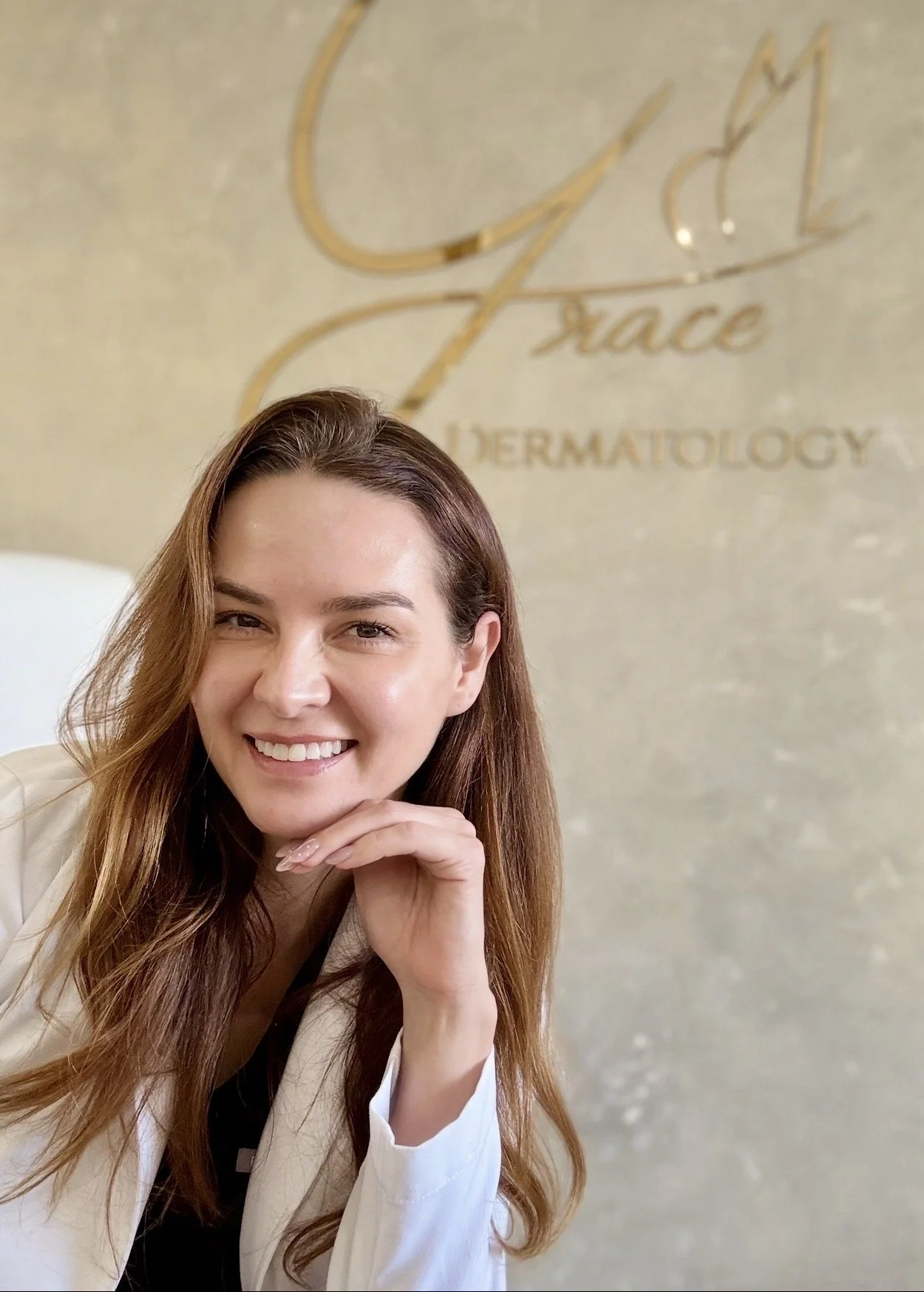 Dr. Lina Kennedy in front of the Grace Dermatology sign at her Los Alamitos office