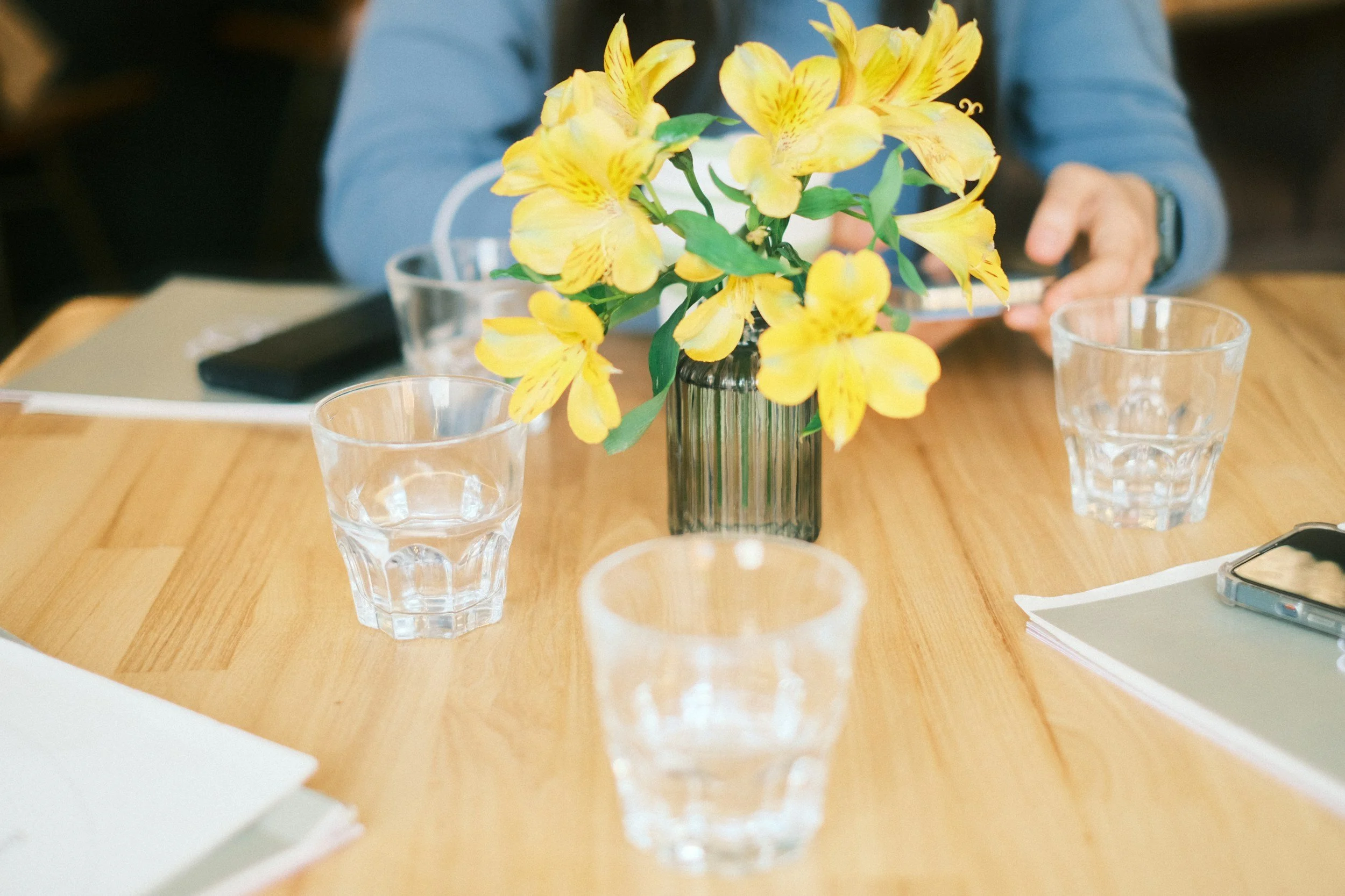 Family tribute guidance discussion with flowers and planning materials on a table