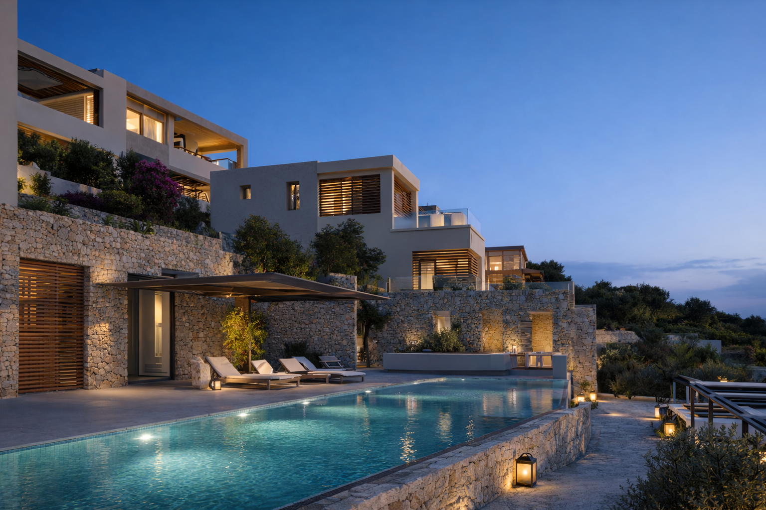 Luxury modern hillside villa with a swimming pool, outdoor lounge chairs, and warm lighting at dusk.