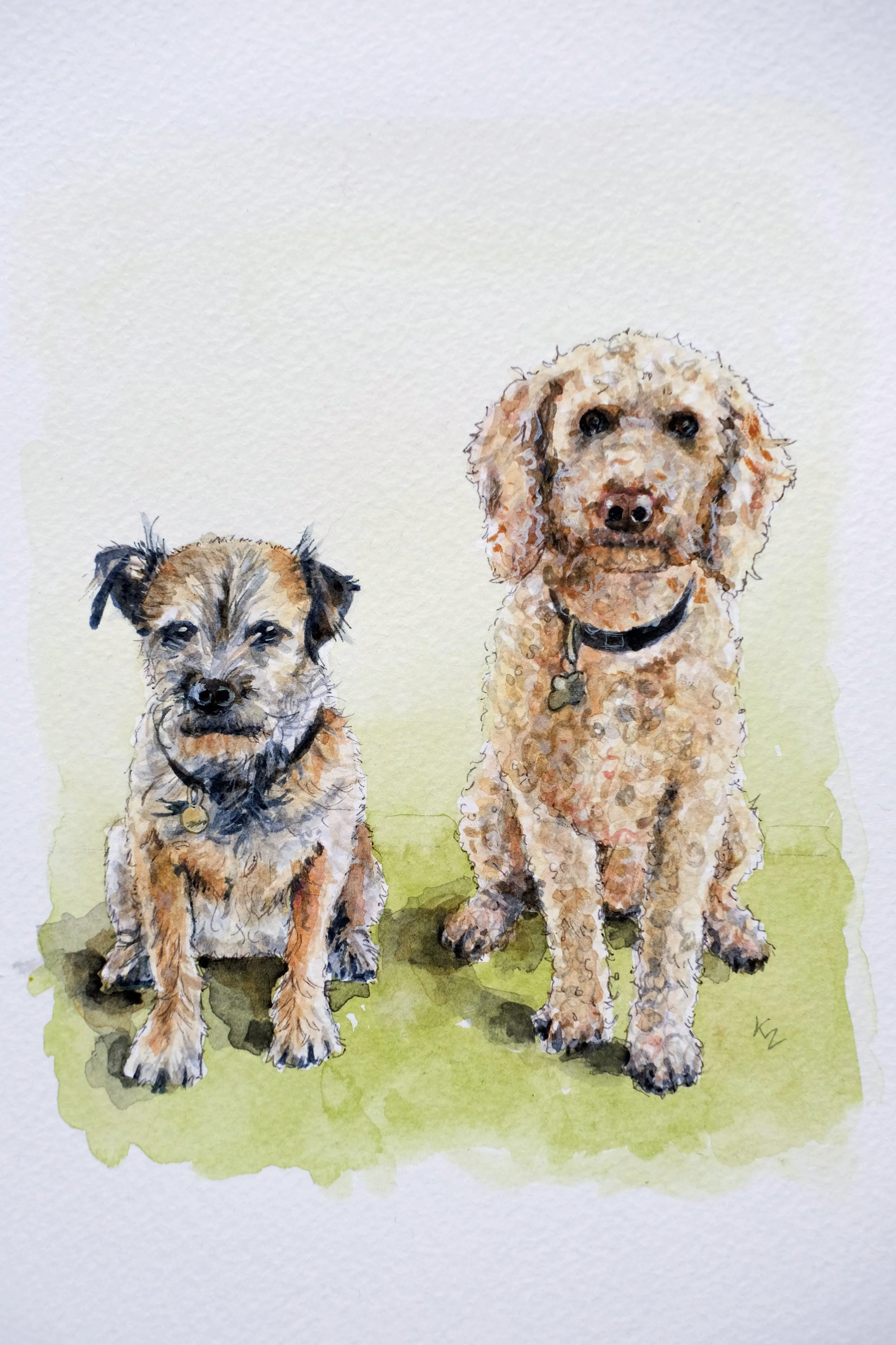 Watercolor painting of two dogs, one small and one large, sitting on a green grassy area. The small dog has a wiry coat and a black collar, and the larger dog has curly fur and a black collar with a bone-shaped tag.