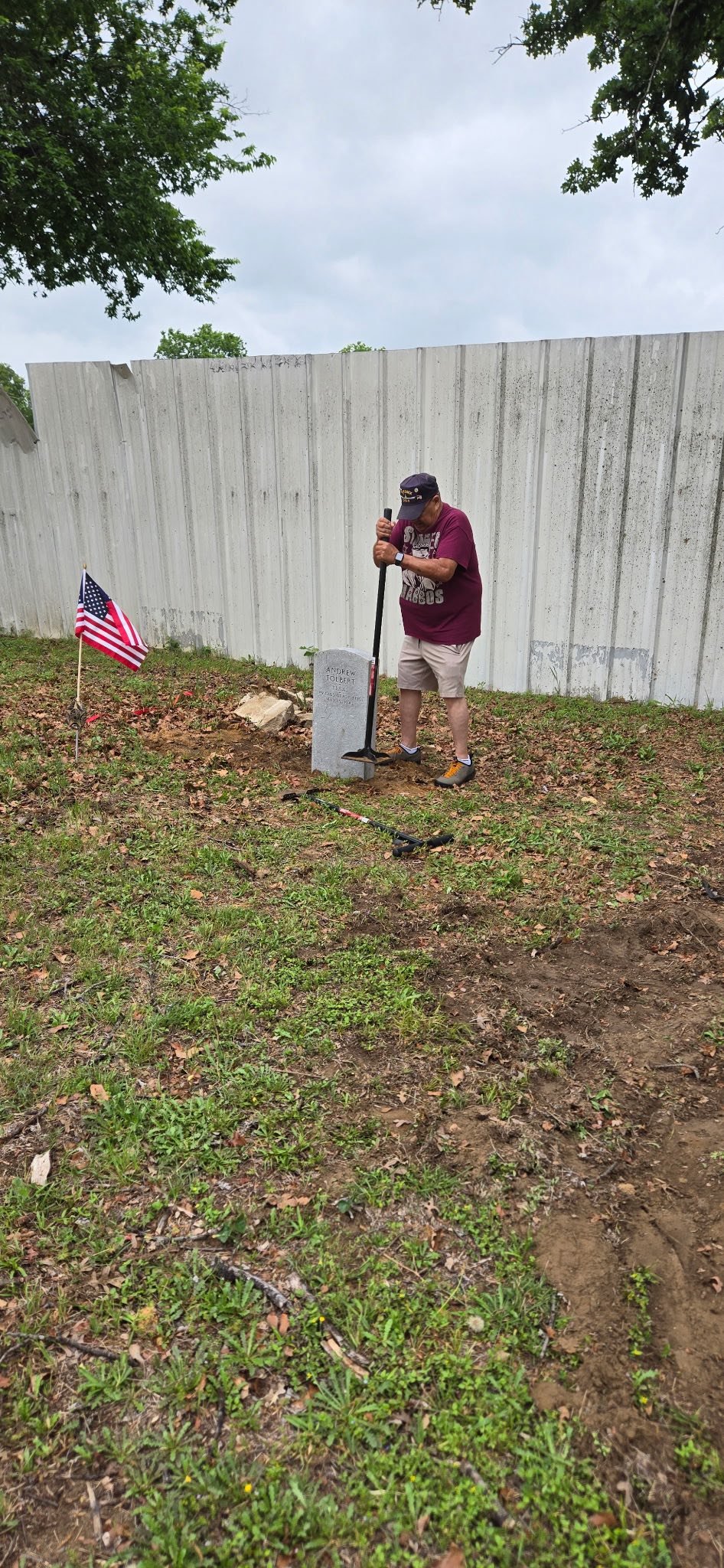 Community Volunteer resetting grave marker.jpg