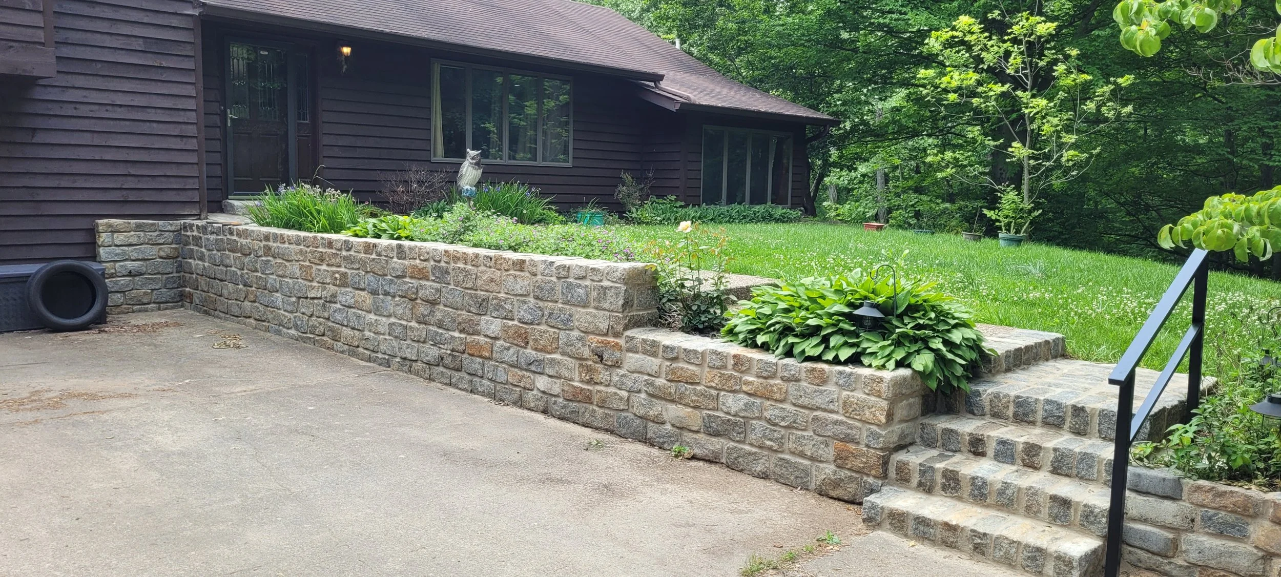 Granite stone retaining wall restoration.