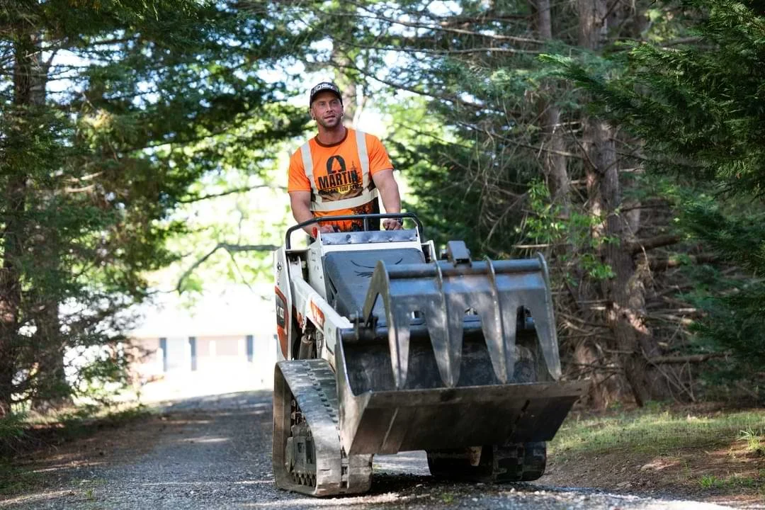 Tree care professional operating compact stump grinding equipment on a residential property in Upstate SC – Martin Tree and Turf Care