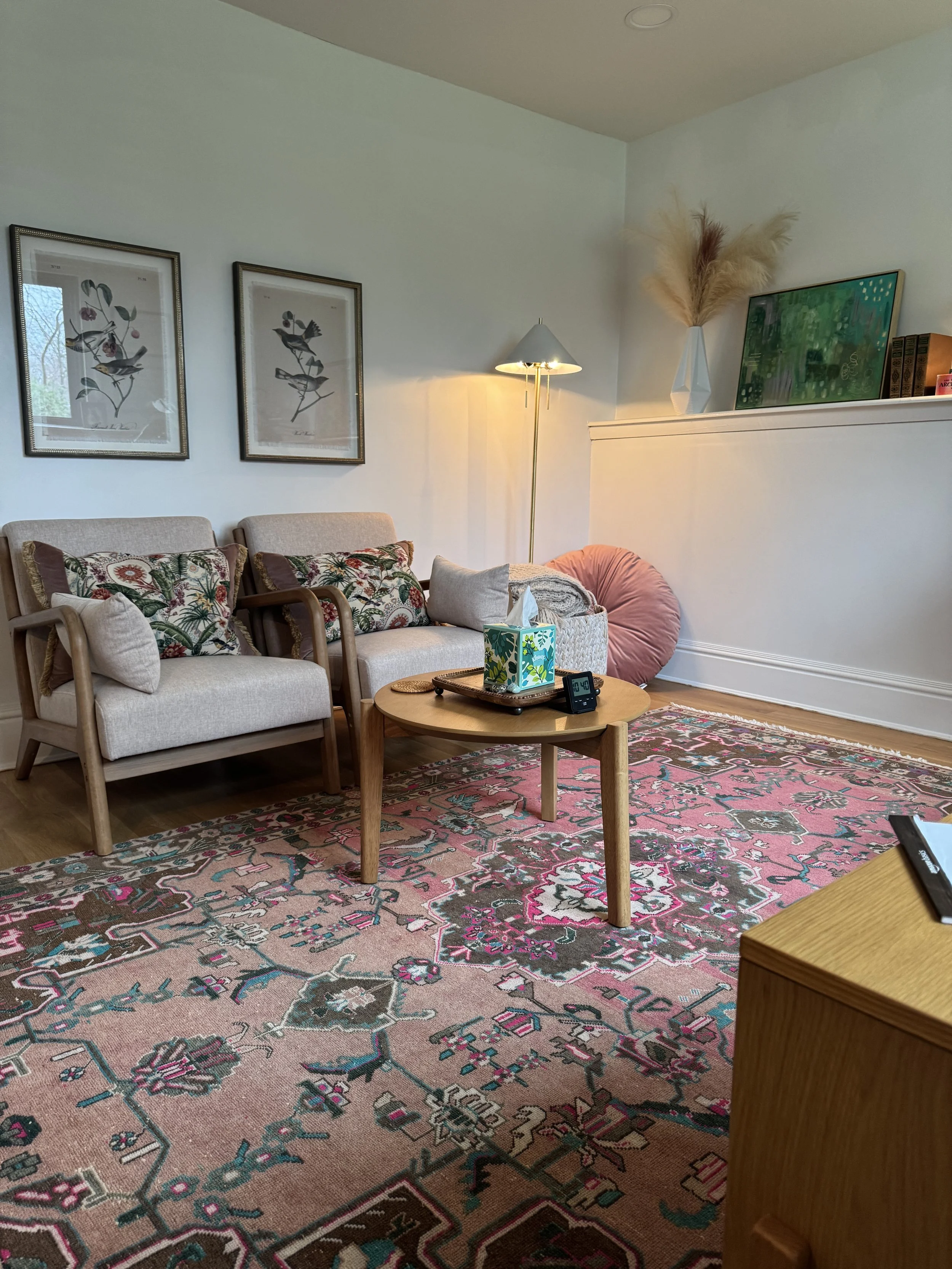 two chairs and a coffee table in a therapist's office